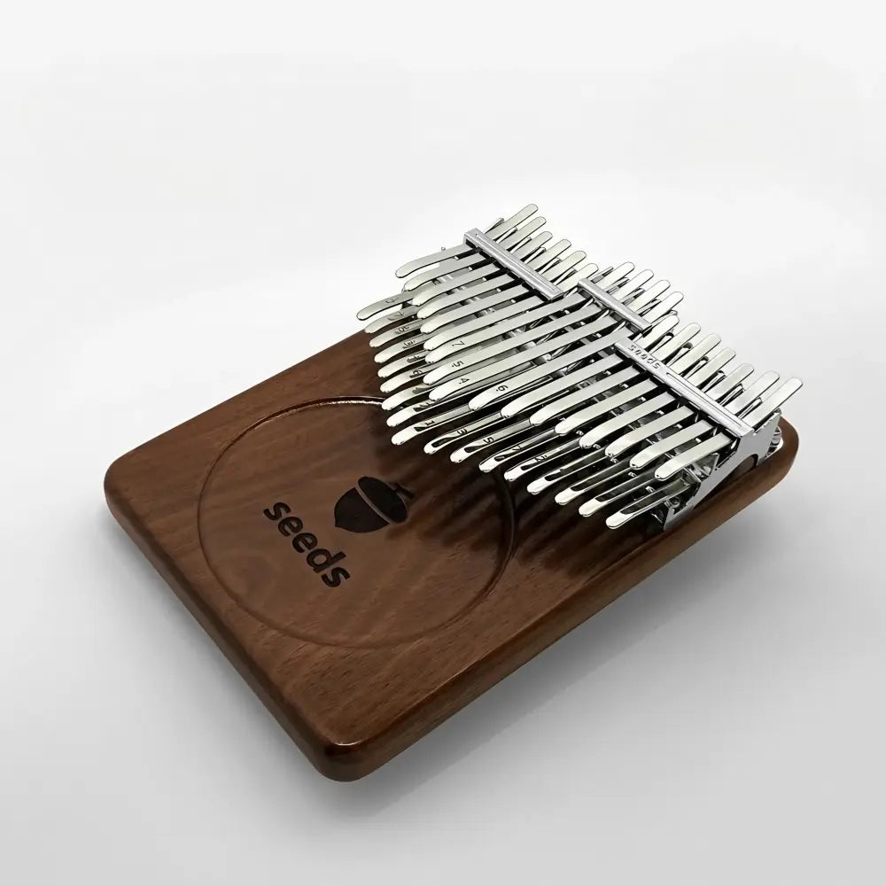 Seeds Chromatic 34 keys kalimba resting elegantly on a wooden surface.