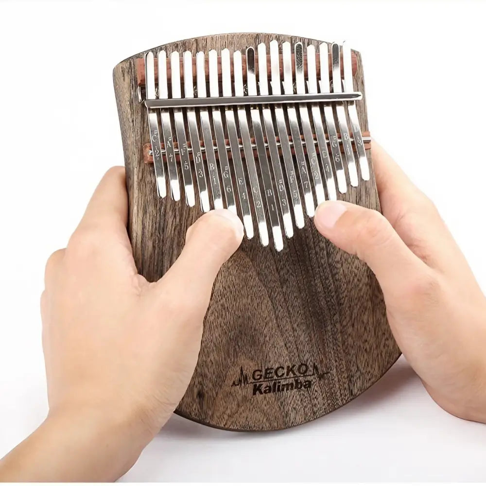 Close-up of hands playing melodies on the Gecko 17 key kalimba.